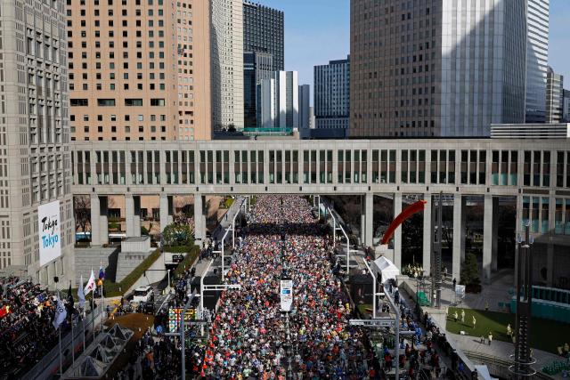Runners set off in front of the Tokyo Metropolitan Government building at the start of the Tokyo Marathon in the Shinjuku area of downtown Tokyo on March 1, 2026. (Photo by Franck ROBICHON / POOL / AFP)