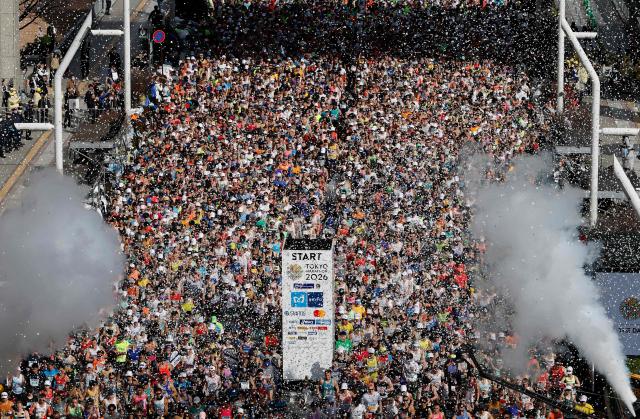 Runners set off in front of the Tokyo Metropolitan Government building at the start of the Tokyo Marathon in the Shinjuku area of downtown Tokyo on March 1, 2026. (Photo by Franck ROBICHON / POOL / AFP)