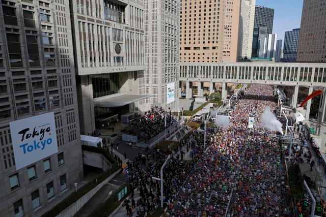 Runners set off in front of the Tokyo Metropolitan Government building at the start of the Tokyo Marathon in the Shinjuku area of downtown Tokyo on March 1, 2026. (Photo by Franck ROBICHON / POOL / AFP)