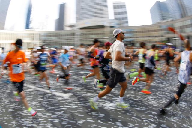A fish-eye view shows runners setting off in front of the Tokyo Metropolitan Government building at the start of the Tokyo Marathon in the Shinjuku area of downtown Tokyo on March 1, 2026. (Photo by Rodrigo Reyes Marin / POOL / AFP)