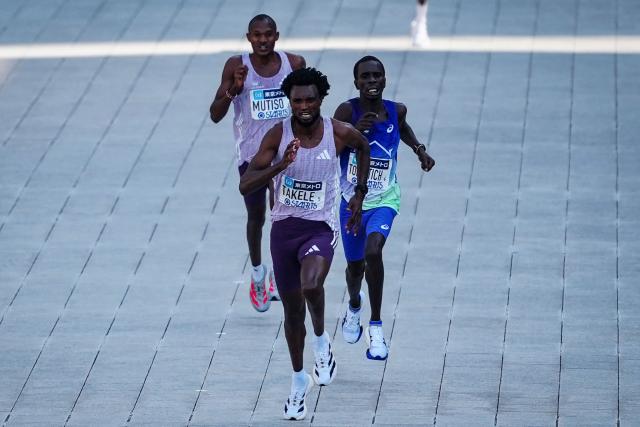 Ethiopia’s Tadese Takele (front) races to the finish line to finish first followed by Kenya’s Geoffrey Toroitich (middle) and Kenya’s Alexander Mutiso (back) in the men's category of the Tokyo Marathon in downtown Tokyo on March 1, 2026. (Photo by JIA HAOCHENG / POOL / AFP)
