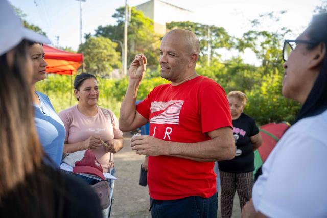 Retired lieutenant colonel of the Venezuelan Air Force and prisoner Rodolfo Polo speaks to relatives after being released from El Rodeo I prison in Guatire, Miranda state, Venezuela on February 28, 2026. Venezuela granted parole to 31 military officers on February 28, reported a lawmaker who is monitoring the “reconciliation” process promoted by the interim government, which includes a historic amnesty law that was just enacted. (Photo by Maryorin Mendez / AFP)