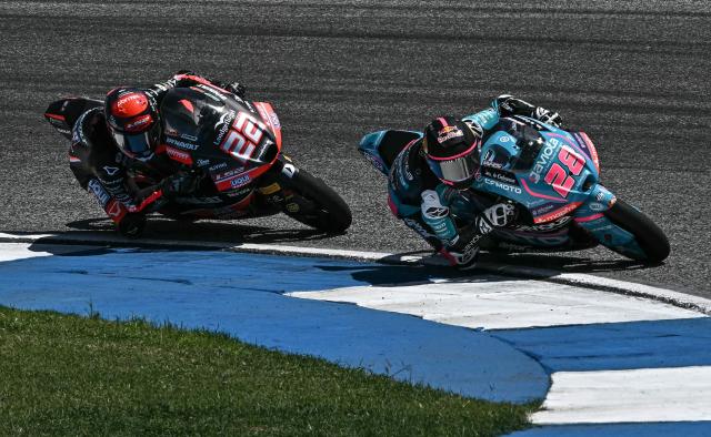 Liqui Moly Dynavolt Intact GP's Spanish rider David Almansa (L) and CFMOTO Gaviota Aspar Team's Spanish rider Maximo Quiles (R) compete during the Moto3 race at the MotoGP Thailand Grand Prix at the Buriram International Circuit in Buriram on March 1, 2026. (Photo by Lillian SUWANRUMPHA / AFP)