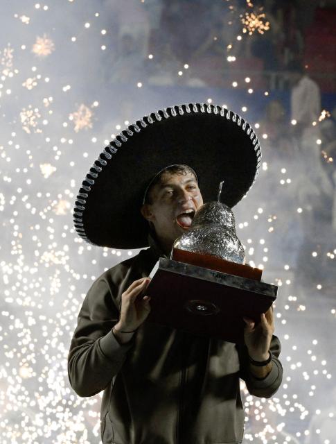 Italy's Flavio Cobolli celebrates with the trophy after defeating US' Frances Tiafoe during the 2026 Mexico ATP 500 Tennis Open men's singles tennis final match at the Arena GNP Seguros in Acapulco, Guerrero State, Mexico on February 28, 2026. (Photo by Alfredo ESTRELLA / AFP)