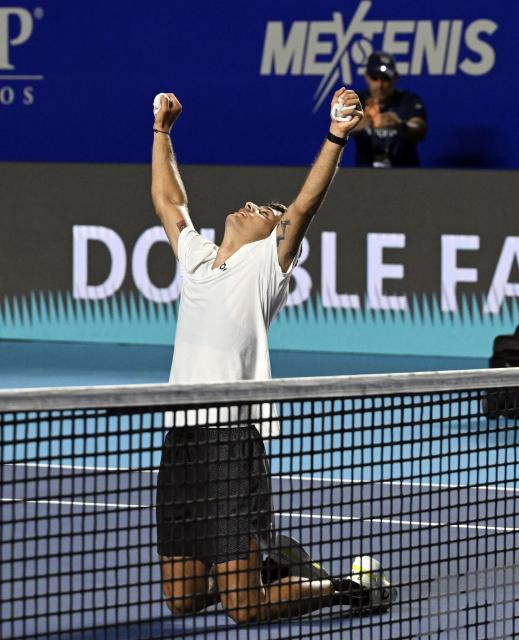 Italy's Flavio Cobolli celebrates his victory against US' Frances Tiafoe during the 2026 Mexico ATP 500 Tennis Open men's singles tennis final match at the Arena GNP Seguros in Acapulco, Guerrero State, Mexico on February 28, 2026. (Photo by Alfredo ESTRELLA / AFP)