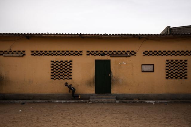 A child runs outside a classroom at the Saint Augustin d'Amoutieve parish in Lome on February 28, 2026. (Photo by OLYMPIA DE MAISMONT / AFP)