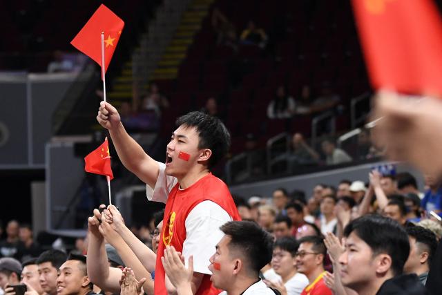 Chinese fans cheer for their team during the 2027 FIBA Basketball World Cup Asian qualifier first round group B match between China and Taiwan at the Mall of Asia Arena in Pasay city, Metro manila on March 1, 2026. (Photo by Ted ALJIBE / AFP)