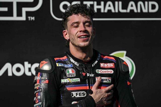 Winner Aprilia Racing's Italian rider Marco Bezzecchi celebrates on the podium after the MotoGP Thailand Grand Prix at the Buriram International Circuit in Buriram on March 1, 2026. (Photo by Lillian SUWANRUMPHA / AFP)