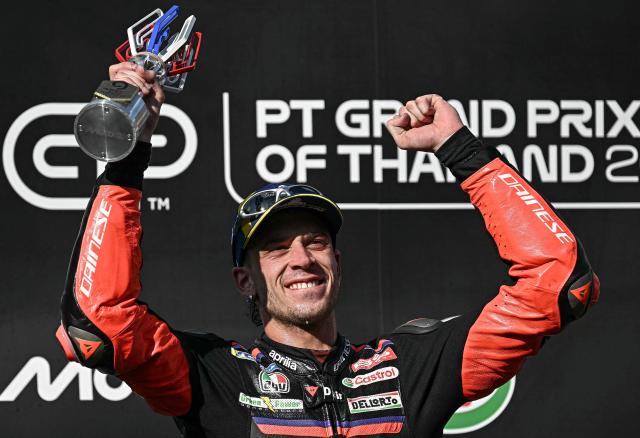 Winner Aprilia Racing's Italian rider Marco Bezzecchi celebrates on the podium after the MotoGP Thailand Grand Prix at the Buriram International Circuit in Buriram on March 1, 2026. (Photo by Lillian SUWANRUMPHA / AFP)