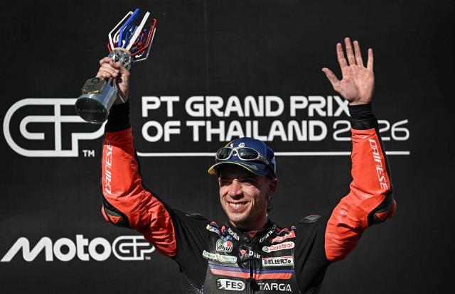 Winner Aprilia Racing's Italian rider Marco Bezzecchi celebrates on the podium after the MotoGP Thailand Grand Prix at the Buriram International Circuit in Buriram on March 1, 2026. (Photo by Lillian SUWANRUMPHA / AFP)