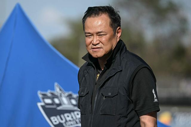 Thai Prime Minister Anutin Charnvirakul arrives on the podium after the MotoGP Thailand Grand Prix at the Buriram International Circuit in Buriram on March 1, 2026. (Photo by Lillian SUWANRUMPHA / AFP)
