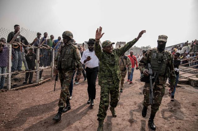 (FILES) M23 armed group spokeperson Willy Ngoma (C) raises his hands as he acknowledges the crowd gathered at the Stade de l'Unite'(Unity Stadium) in Goma on February 6, 2025 during a public gathering called by the armed group. The Rwanda-backed M23 force fighting in eastern DR Congo said February 28, 2026 that its military spokesman had been killed in a Congolese army drone strike.
The announcement came days after government forces in the Democratic Republic of Congo (DRC) targeted the armed group with a drone strike near Rubaya, a strategic mining town in Masisi territory in North Kivu province. (Photo by Jospin mwisha / AFP)