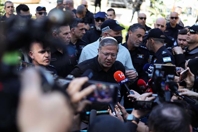 Israel's far-right National Security Minister Itamar Ben Gvir (C) speaks to journalists as he visits an area that was hit by a reported overnight Iranian strike in Tel Aviv on March 1, 2026. Ayatollah Ali Khamenei, Iran's supreme leader since 1989 and sworn enemy of the West, was killed in the opening salvo of a massive US and Israeli attack, sparking a new wave of retaliatory missile strikes from Tehran on March 1. (Photo by Ilia YEFIMOVICH / AFP)