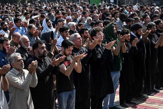 Pakistani Shiite Muslims offer prayers during a protest to condemn the US-Israel attack on Iran, in Lahore on March 1, 2026. Iranian state television confirmed the death of its supreme leader Ayatollah Ali Khamenei and launched a fresh wave of attacks on March 1, as Israel hit back at the capital Tehran. In Pakistan, eight people were killed as hundreds of protesters tried to storm the US consulate in the megacity of Karachi, the local rescue service said. (Photo by Arif ALI / AFP)