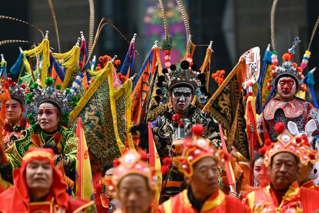 Dancers take part in a Chinese New Year performance of traditional dances at the plaza of the Museum of the Communist Party of China in Beijing on March 1, 2026, ahead of the opening of the annual session of the National People's Congress (NPC). (Photo by Pedro PARDO / AFP)