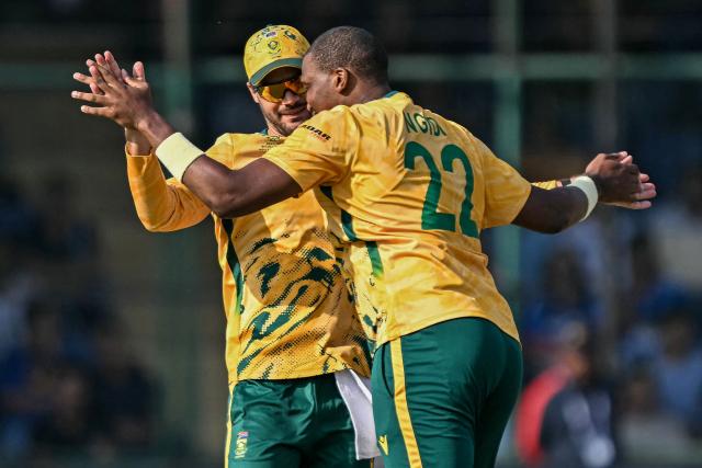 South Africa's Lungi Ngidi (R) celebrates with captain Aiden Markram after taking the wicket of Zimbabwe's Ryan Burl during the 2026 ICC Men's T20 Cricket World Cup Super Eights match between Zimbabwe and South Africa at the Arun Jaitley Stadium in New Delhi on March 1, 2026. (Photo by Sajjad HUSSAIN / AFP)