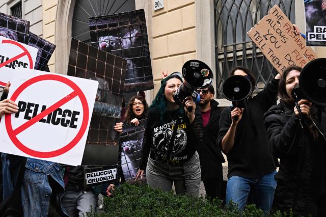 Protestors hold signs ahead of the Giorgio Armani womens's ready-to-wear Fall/Winter 2026 collection fashion show as part of the Milan Fashion Week, in Milan on March 1, 2026. (Photo by Miguel MEDINA / AFP)