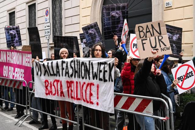 Protestors hold signs reading "Ban fur" ahead of the Giorgio Armani womens's ready-to-wear Fall/Winter 2026 collection fashion show as part of the Milan Fashion Week, in Milan on March 1, 2026. (Photo by Miguel MEDINA / AFP)