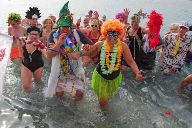 Revellers attend the traditional carnival bath during the 141th edition of the Nice Carnival on the French riviera city of Nice on March 1, 2026. (Photo by Valery HACHE / AFP)