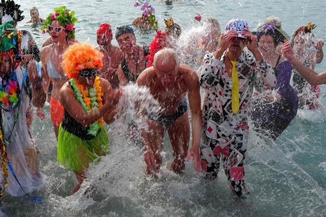 Revellers attend the traditional carnival bath during the 141th edition of the Nice Carnival on the French riviera city of Nice on March 1, 2026. (Photo by Valery HACHE / AFP)