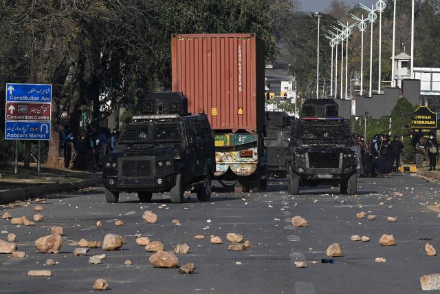 Riot police stand guard as Shiite Muslims block a road during their attempt to storm the US embassy in Islamabad on March 1, 2026 after the death of Iran's supreme leader Ayatollah Ali Khamenei amid US-Israel strikes. At least nine people were killed during pro-Iran protests at the United States consulate in the Pakistan megacity of Karachi on March 1, according to a hospital toll seen by AFP. (Photo by Aamir QURESHI / AFP)