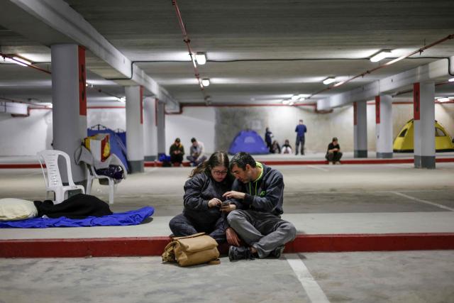 People take shelter in an underground car park in Haifa on March 1, 2026, amid Iranian attack fears. Iran launched strikes across the Gulf on March 1 after vowing to avenge slain supreme leader Ayatollah Ali Khamenei, defying a threat from President Donald Trump to strike with unprecedented force. (Photo by Jalaa MAREY / AFP)