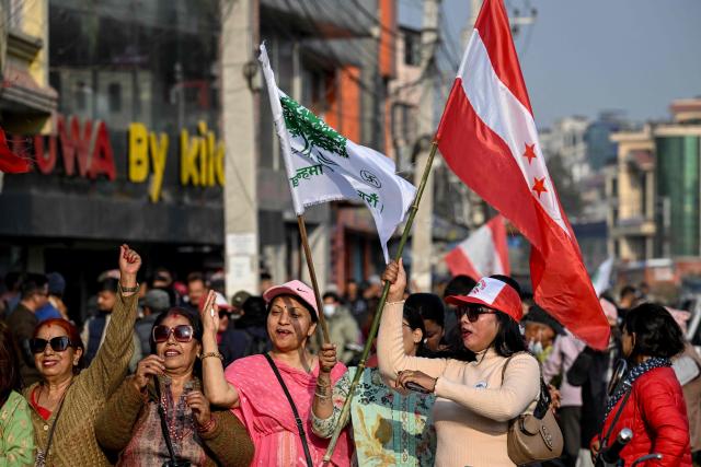Supporters waving flags attend a rally for Nepali Congress party president and election candidate Gagan Thapa in Kathmandu on March 1, 2026 ahead of parliamentary elections in Nepal. (Photo by TAUSEEF MUSTAFA / AFP)