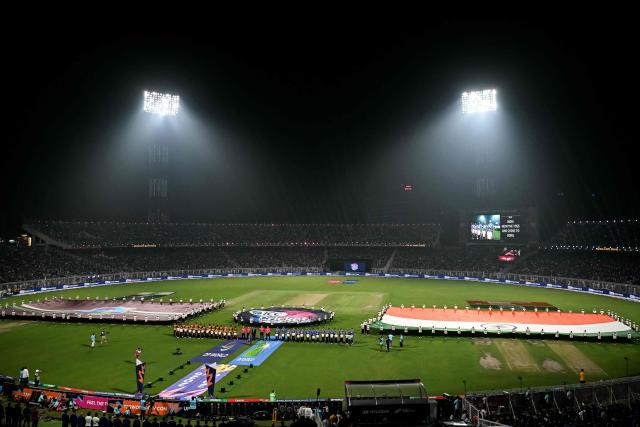 India and West Indies team players stand for the national anthem before the start of their 2026 ICC Men's T20 Cricket World Cup Super Eights match at the Eden Gardens in Kolkata on March 1, 2026. (Photo by Dibyangshu SARKAR / AFP)