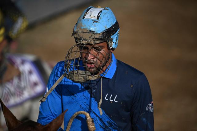 A cowboy gestures during a bull-tailing competition held as part of the "Fiestas del Alma Llanera" celebration in San Fernando de Apure, Apure State, Venezuela, on February 27, 2026. Bull tailing is very popular in the plains of Venezuela. It is a professional discipline throughout the country and attracts thousands of spectators, but it also faces harsh criticism for animal mistreatment from activists and outsiders. (Photo by Federico PARRA / AFP)