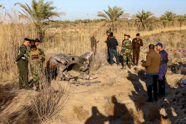 Members and officers from the Iraqi Interior Ministry's Explosives Directorate inspect the fuel tank of a rocket that landed in a rural village in the Siyahi area near the city of Hilla in the central Babil province on March 1, 2026. Iraq, which has recently regained a sense of stability but has long been a proxy battleground between the US and Iran, warned that it did not want to be dragged into the war that started on February 28 with US and Israeli strikes on Iran. (Photo by Karrar Jabbar / AFP)