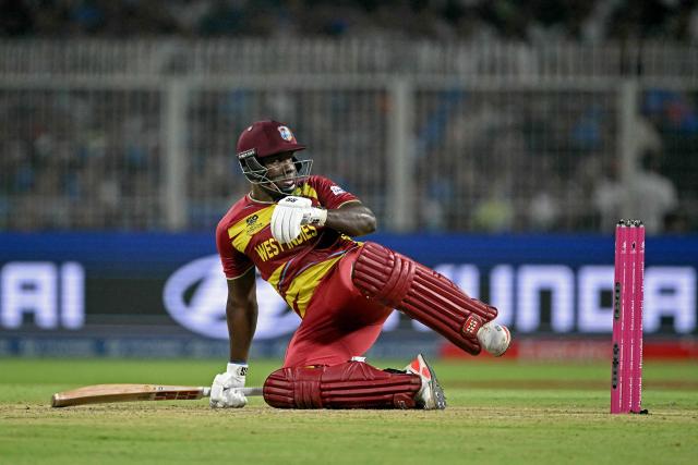 West Indies' Rovman Powell falls after playing a shot during the 2026 ICC Men's T20 Cricket World Cup Super Eights match between India and West Indies at the Eden Gardens in Kolkata on March 1, 2026. (Photo by Dibyangshu SARKAR / AFP)
