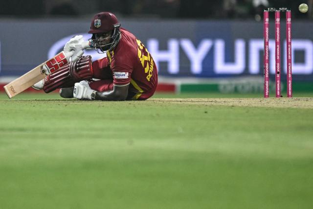 West Indies' Rovman Powell falls on the ground after playing a shot during the 2026 ICC Men's T20 Cricket World Cup Super Eights match between India and West Indies at the Eden Gardens in Kolkata on March 1, 2026. (Photo by Arun SANKAR / AFP)