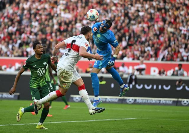 (From L) Wolfsburg's Polish goalkeeper #01 Kamil Grabara saves the ball against Stuttgart's Bosnian forward #09 Ermedin Demirovic during the German first division Bundesliga football match between VfB Stuttgart and VfL Wolfsburg in Stuttgart, southern Germany, on March 1, 2026. (Photo by THOMAS KIENZLE / AFP) / DFL REGULATIONS PROHIBIT ANY USE OF PHOTOGRAPHS AS IMAGE SEQUENCES AND/OR QUASI-VIDEO