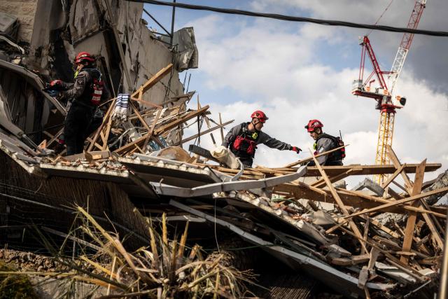 Israeli emergency service officers inspect search through the debris at the scene of a missile attack in Bet Shemesh, some 30 kilometres west of Jerusalem on March 1, 2026. A barrage of missiles launched from Iran killed at least six people in the central Israel city of Bet Shemesh on March 1, Israel's first responders agency, Magen David Adom (MDA) said, the day after the US and Israel attacked Iran and assassinated its supreme leader. (Photo by JOHN WESSELS / AFP)