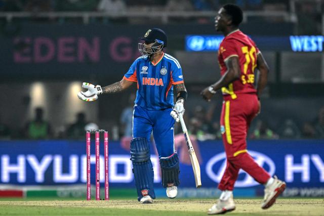 India's captain Suryakumar Yadav (L) reacts after his dismissal during the 2026 ICC Men's T20 Cricket World Cup Super Eights match between India and West Indies at the Eden Gardens in Kolkata on March 1, 2026. (Photo by Arun SANKAR / AFP)