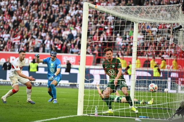 Wolfsburg's German defender #25 Aaron Zehnter (R) fails to keep the ball out of the net for the 4-0 goal during the German first division Bundesliga football match between VfB Stuttgart and VfL Wolfsburg in Stuttgart, southern Germany, on March 1, 2026. (Photo by THOMAS KIENZLE / AFP) / DFL REGULATIONS PROHIBIT ANY USE OF PHOTOGRAPHS AS IMAGE SEQUENCES AND/OR QUASI-VIDEO
