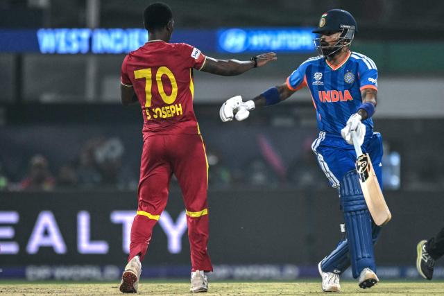 India's Hardik Pandya (R) reacts after colliding with West Indies' Shamar Joseph during the 2026 ICC Men's T20 Cricket World Cup Super Eights match between India and West Indies at the Eden Gardens in Kolkata on March 1, 2026. (Photo by Arun SANKAR / AFP)