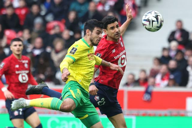 Nantes' French defender #18 Fabien Centonze (CL) and Lille's French midfielder #21 Benjamin Andre (CR) fight for the ball during the French L1 football match between Lille LOSC and FC Nantes at the Stade Pierre-Mauroy in Villeneuve-d'Ascq, northern France, on March 1, 2026. (Photo by Francois LO PRESTI / AFP)