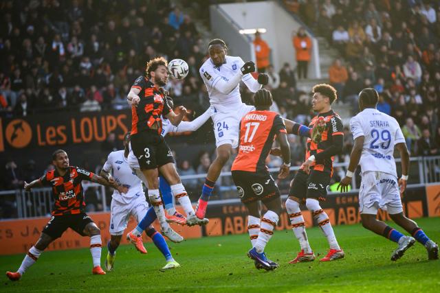 Lorient's Tunisian defender #03 Montassar Talbi (L) jumps for the ball with Auxerre's Swiss defender #24 Bryan Okoh during the French L1 football match between FC Lorient and AJ Auxerre at the Stade du Moustoir in Lorient, western France on March 1, 2026. (Photo by Loic VENANCE / AFP)