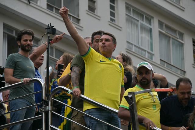 Senator and presidential candidate Flavio Bolsonaro (C) gestures to supporters of Brazil's former president Jair Bolsonaro (2019-2022), sentenced to 23 years and 3 months for attempted coup, during a demonstration in Sao Paulo, Brazil, on March 1, 2026. (Photo by NELSON ALMEIDA / AFP)