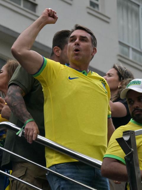 Senator and presidential candidate Flavio Bolsonaro gestures to supporters of Brazil's former president Jair Bolsonaro (2019-2022), sentenced to 23 years and 3 months for attempted coup, during a demonstration in Sao Paulo, Brazil, on March 1, 2026. (Photo by NELSON ALMEIDA / AFP)