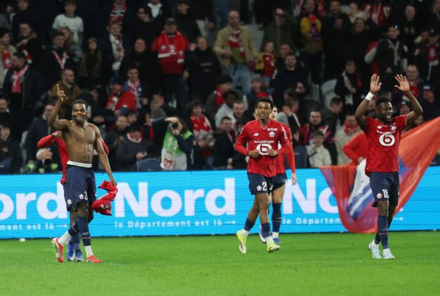 Lille's Belgian defender #03 Nathan Ngoy (L) celebrates with teammates after scoring Lille's first goal during the French L1 football match between Lille LOSC and FC Nantes at the Stade Pierre-Mauroy in Villeneuve-d'Ascq, northern France, on March 1, 2026. (Photo by Francois LO PRESTI / AFP)