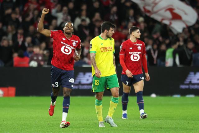 Lille's Belgian defender #03 Nathan Ngoy (L) after scoring Lille's first goal during the French L1 football match between Lille LOSC and FC Nantes at the Stade Pierre-Mauroy in Villeneuve-d'Ascq, northern France, on March 1, 2026. (Photo by Francois LO PRESTI / AFP)