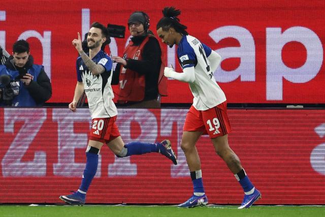 Hamburg's Portuguese midfielder #20 Fabio Vieira (L) celebrates scoring the opening goal with his teammate Hamburg's US forward #19 Damion Downs during the German first division Bundesliga football match between Hamburger SV and RB Leipzig in Hamburg, northern Germany on March 1, 2026. (Photo by IBRAHIM OT / AFP) / DFL REGULATIONS PROHIBIT ANY USE OF PHOTOGRAPHS AS IMAGE SEQUENCES AND/OR QUASI-VIDEO