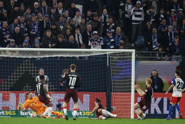 Hamburg's Portuguese midfielder #20 Fabio Vieira (R) scores the opening goal past Leipzig's Belgian goalkeeper #26 Maarten Vandevoordt during the German first division Bundesliga football match between Hamburger SV and RB Leipzig in Hamburg, northern Germany on March 1, 2026. (Photo by IBRAHIM OT / AFP) / DFL REGULATIONS PROHIBIT ANY USE OF PHOTOGRAPHS AS IMAGE SEQUENCES AND/OR QUASI-VIDEO