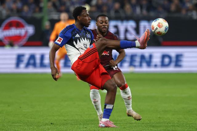 Hamburg's Nigerian froward Philip Otele #27 (L) and Leipzig's German midfielder #17 Ridle Baku vie for the ball during the German first division Bundesliga football match between Hamburger SV and RB Leipzig in Hamburg, northern Germany on March 1, 2026. (Photo by IBRAHIM OT / AFP) / DFL REGULATIONS PROHIBIT ANY USE OF PHOTOGRAPHS AS IMAGE SEQUENCES AND/OR QUASI-VIDEO