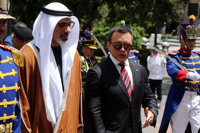 Abu Dhabi's Crown Prince Sheikh Khaled bin Mohamed bin Zayed Al Nahyan (L) listens to Ecuador's President Daniel Noboa as they arrive at the Independence Square to lay a floral offering during a visit in Quito on March 1, 2026. (Photo by Galo Paguay / AFP)