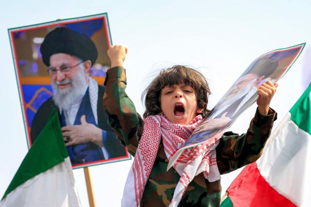 A boy holds a picture of Iran's supreme leader Ali Khamenei during a memorial rally held by supporters of Yemen's Huthis, a day after Khamenei was assassinated during US and Israeli strikes on Tehran, in the Huthi-held capital Sanaa on March 1, 2026. The United States and Israel launched strikes against Iran on February 28, killing Iran's supreme leader and top military leaders, prompting authorities to retaliate with strikes on Israel and US bases across the Gulf. (Photo by Mohammed HUWAIS / AFP)
