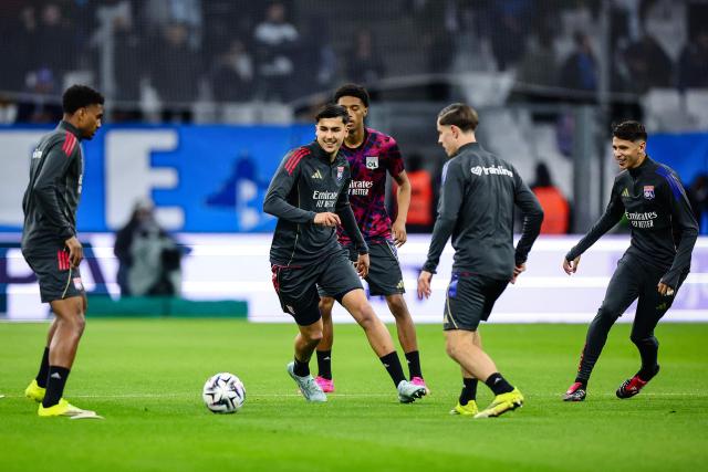 Lyon's players warm up ahead of the French L1 football match between Olympique de Marseille (OM) and Olympique Lyonnais (OL) at the Stade Velodrome in Marseille, southern France, on March 1, 2026. (Photo by CLEMENT MAHOUDEAU / AFP)