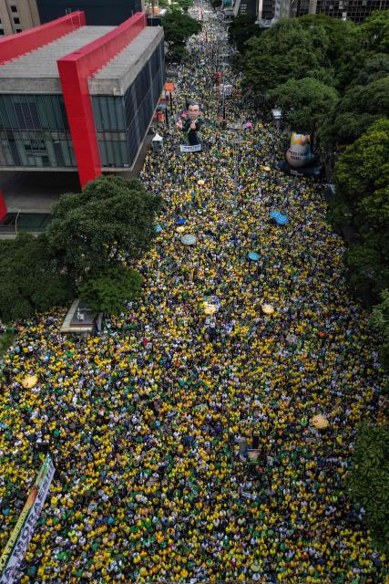 Aerial view of supporters of Brazil's former president Jair Bolsonaro (2019-2022), sentenced to 23 years and 3 months for attempted coup, taking part in a demonstration in Sao Paulo, Brazil, on March 1, 2026. (Photo by Nelson ALMEIDA / AFP)